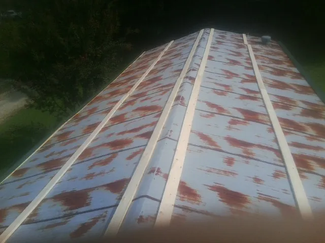 Rusted metal roof panels with new wood purlins before replacement — Storm Damage Roof Repair in Woodland Hills by Roofing Brothers