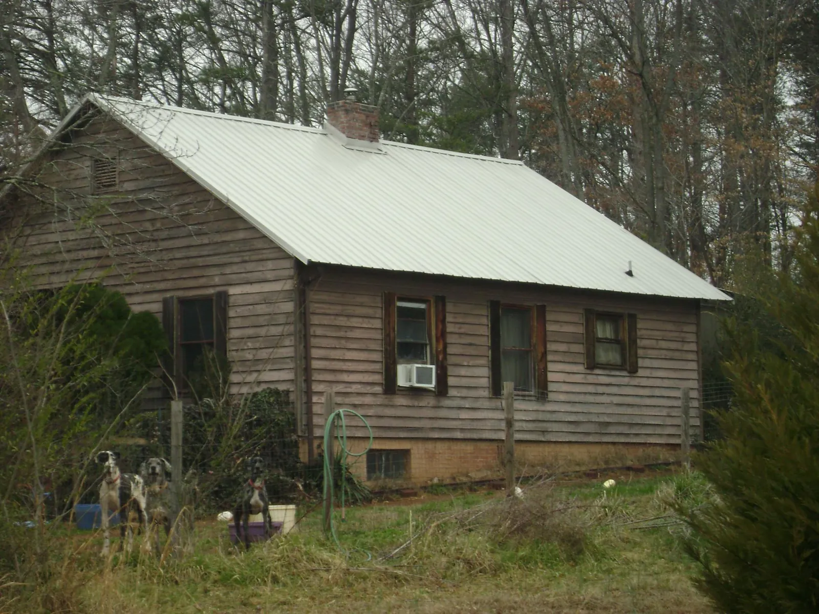 White metal roof on an old wood sided farmhouse, from a Asphalt Shingle Roof Repair job in Woodland Hills